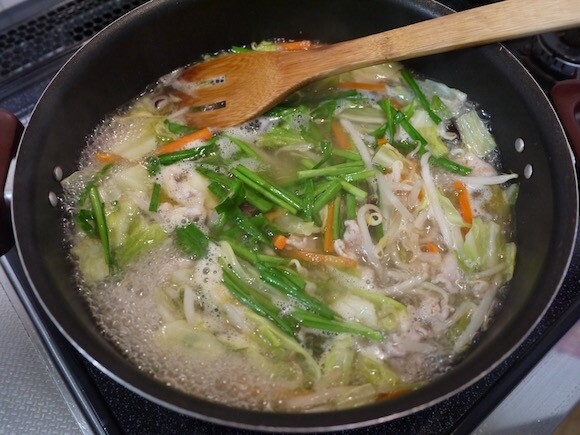 3. 將韭菜和魚露加入平底鍋中拌炒。接著加入溫熱的雞骨高湯與鹽。■ 祕訣
